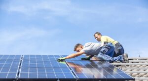 two people installing solar panels