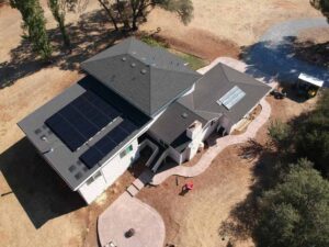 aerial view of large home with solar panels