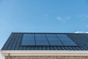solar panels attached on the roof against a sunny sky