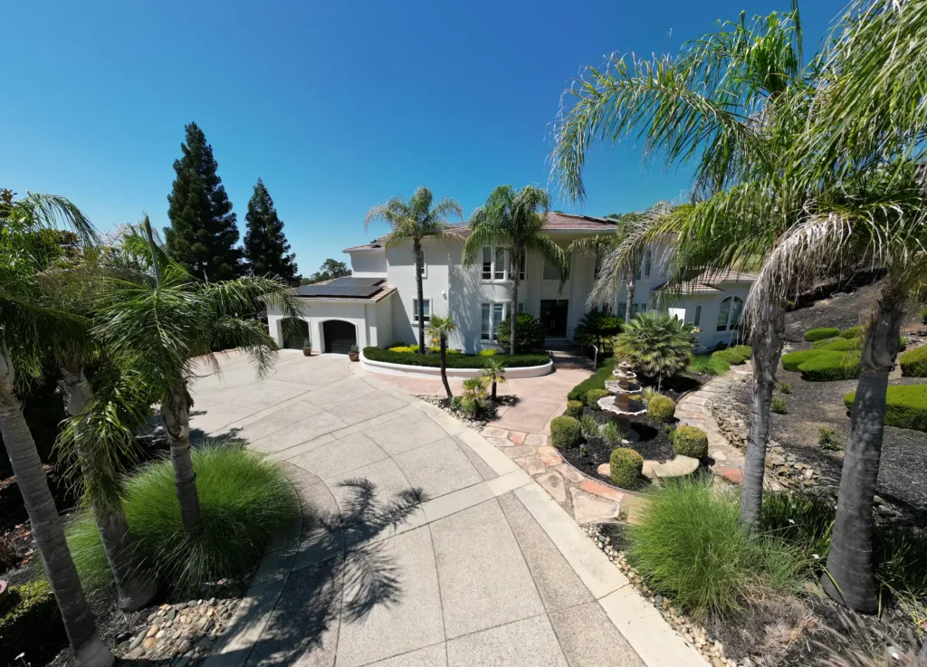 Tropical lakeside mansion equipped with ACR Solar installed solar panels.